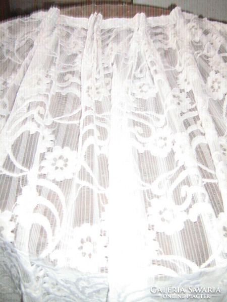 A white curtain richly embroidered in a beautiful material