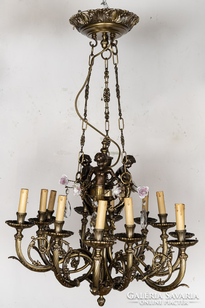 Gilded bronze chandelier with plastic putto figures and ram's head decoration