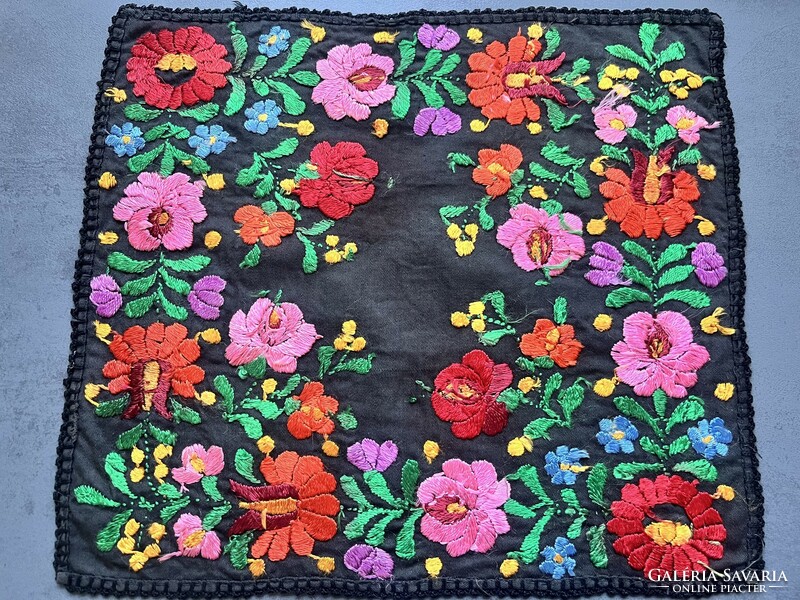 A wonderful, soft, richly embroidered placemat with silk