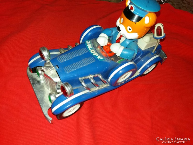 Antique jallopy toy car with battery-powered vinyl that works beautifully and makes a sound, according to the pictures
