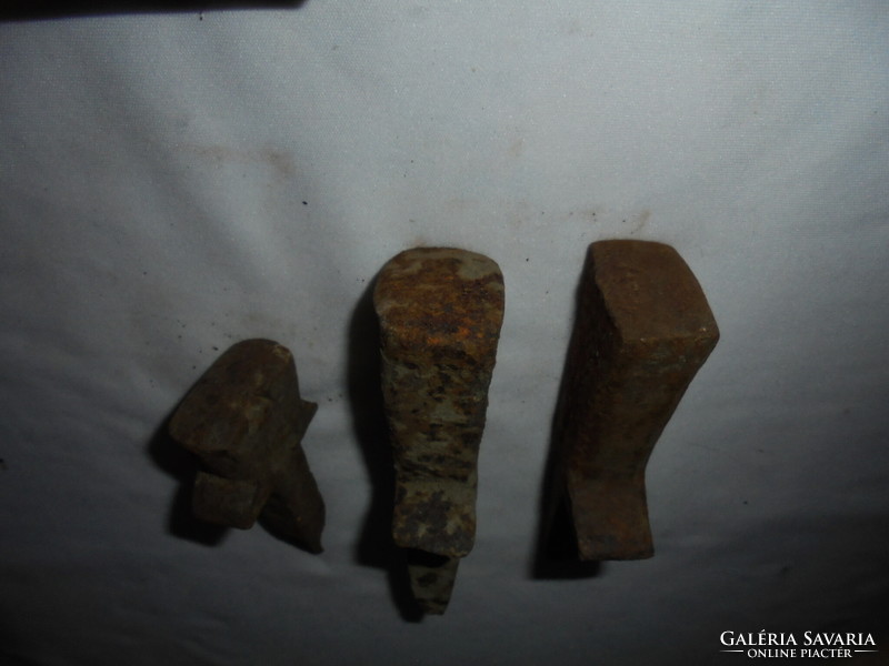 Three small forged iron anvils together - for sharpening scythes