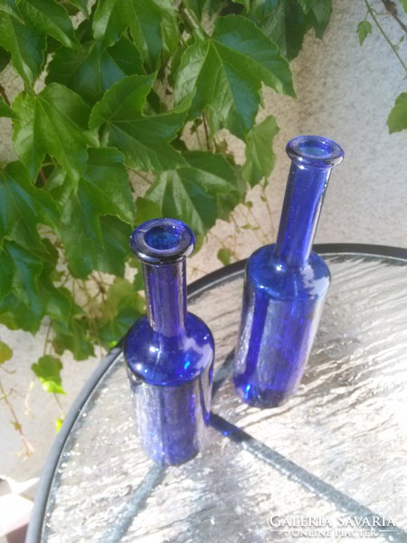 Drunken glass bottles with blue slanted bottoms