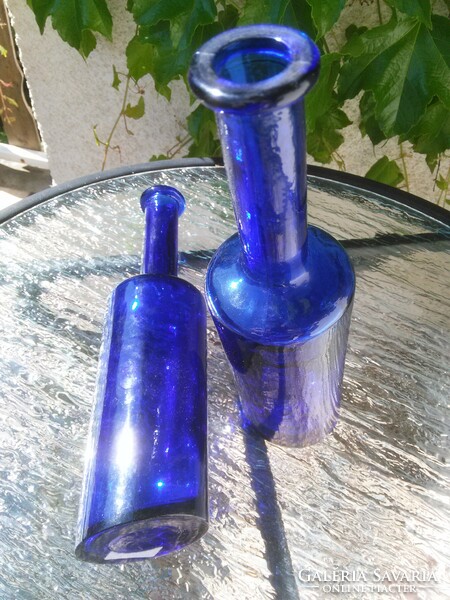 Drunken glass bottles with blue slanted bottoms