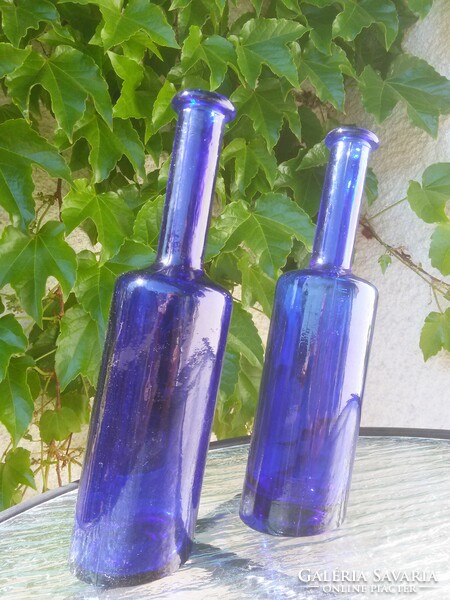 Drunken glass bottles with blue slanted bottoms