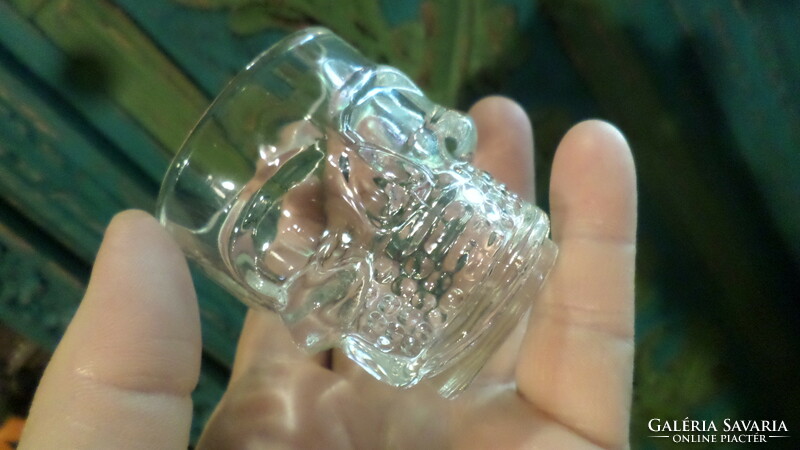 2 pressed glass cups in the shape of a skull, in good condition.