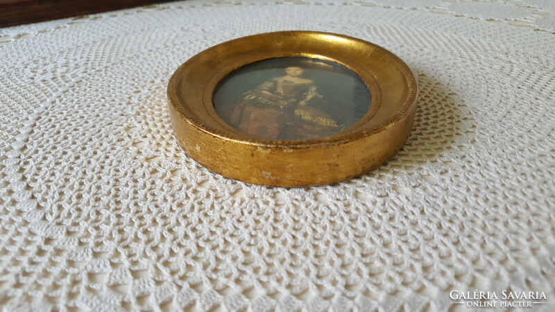 Beautiful gilded female portrait in an oval frame