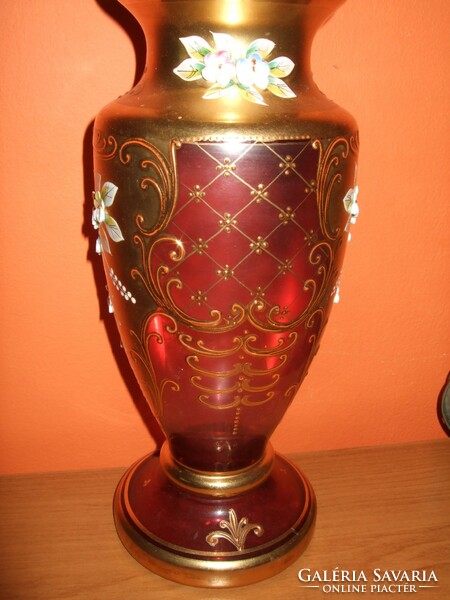 Ruby red vase, richly gilded, decorated with plastic flowers