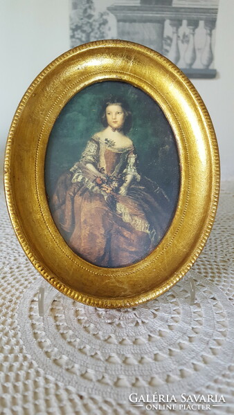Beautiful gilded female portrait in an oval frame