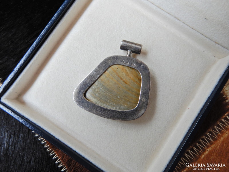 Old silver pendant with a special mineral