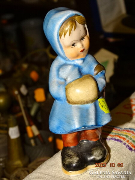 Old brightly colored painted ceramic girl with umbrella