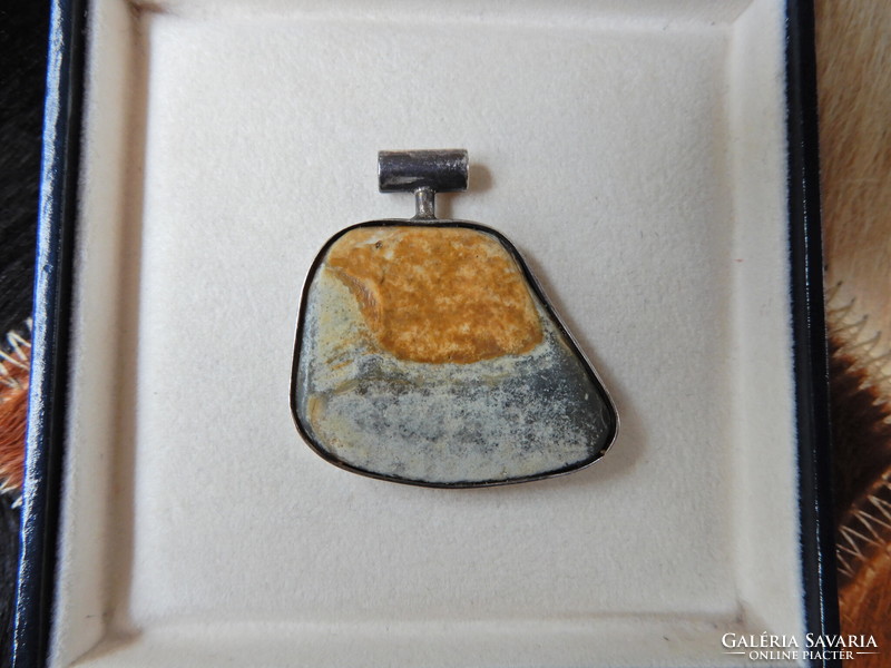 Old silver pendant with a special mineral