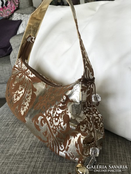 Italian braccialini leather shoulder bag on a medium brown base with an antique gold printed pattern