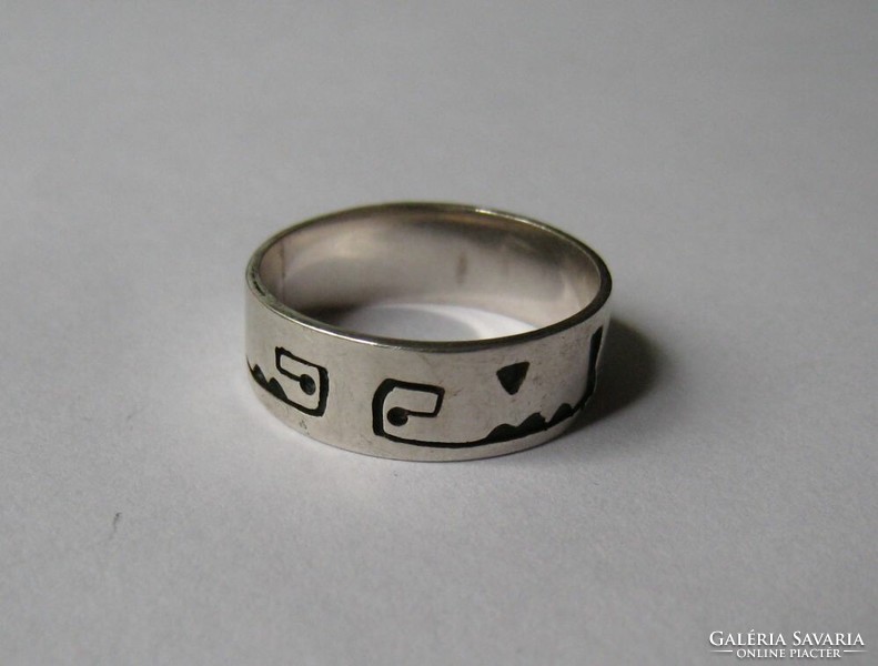 Silver wedding ring with interesting signs