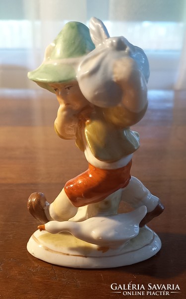 Porcelain figurine of a little boy with a bat and a goose