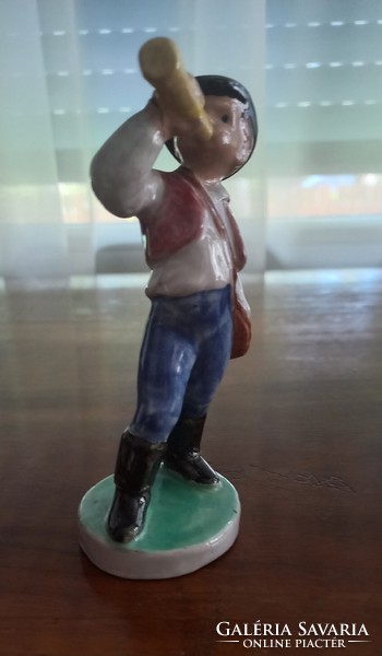 Porcelain figurine of a little boy blowing a horn