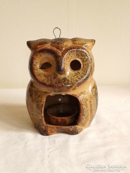 Old glazed ceramic candle holder, candle holder, in the shape of an owl figure, mood lighting