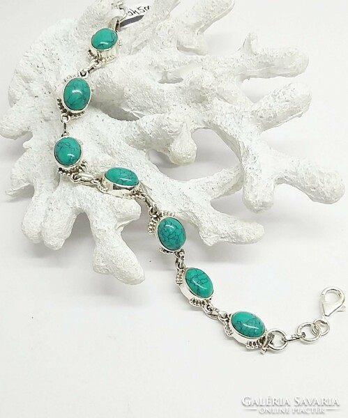 Silver bracelet with turquoise stone.