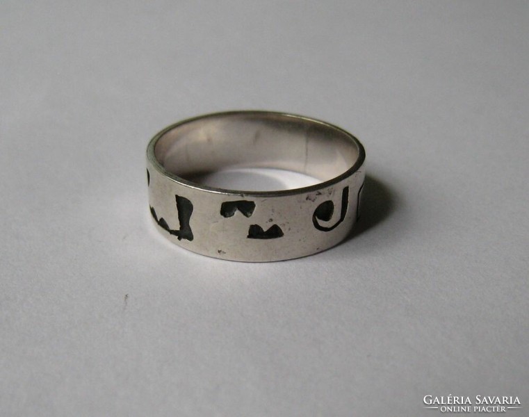 Silver wedding ring with interesting signs