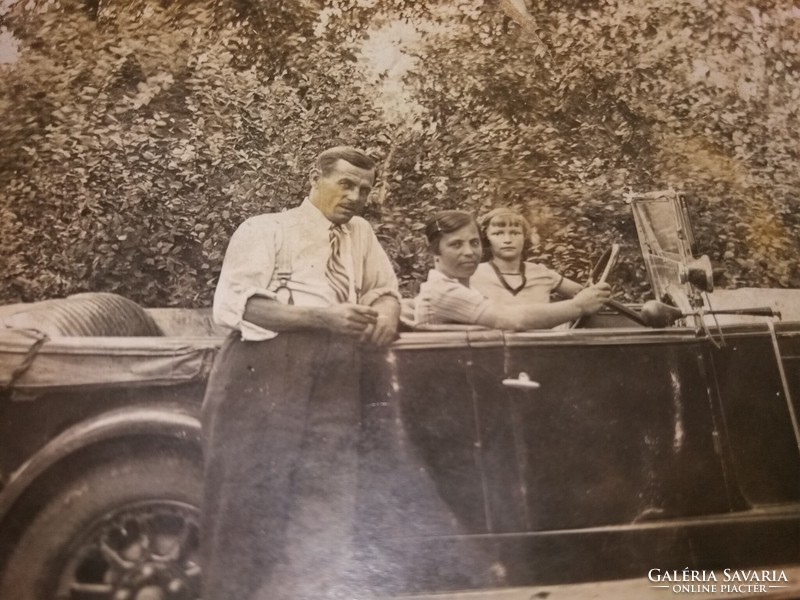 Antique sepia postcard of the proud owner and his family with perhaps a rover (?) car according to the pictures