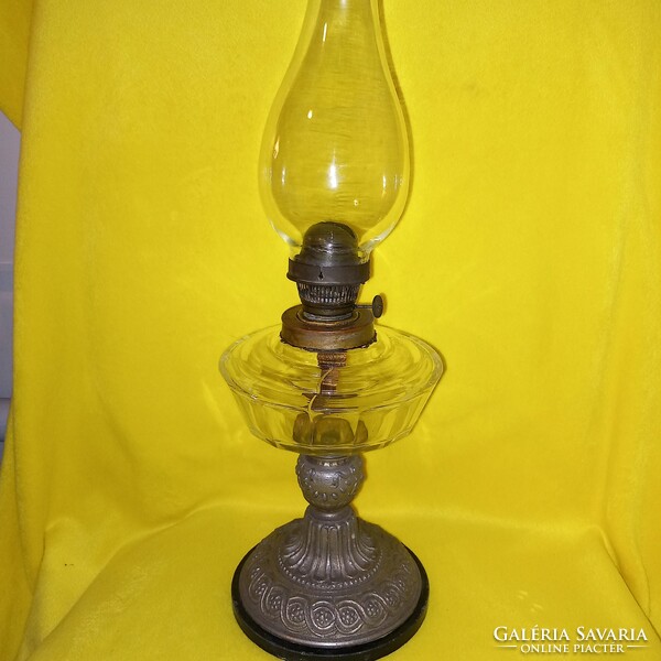 Old table kerosene lamp, metal base, glass container.