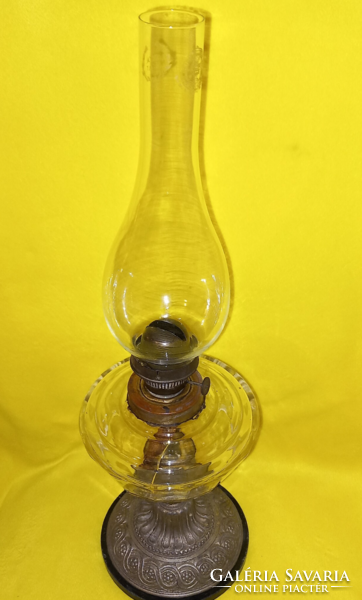 Old table kerosene lamp, metal base, glass container.