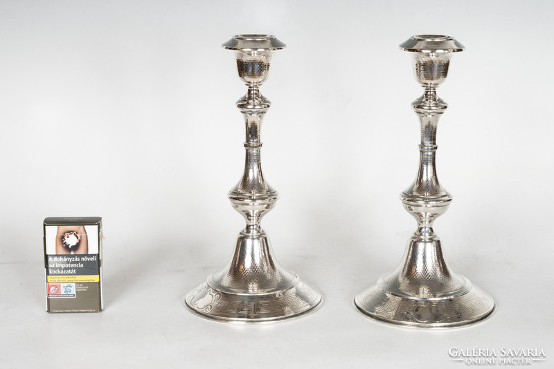 Pair of silver candle holders with delicately chiseled decor
