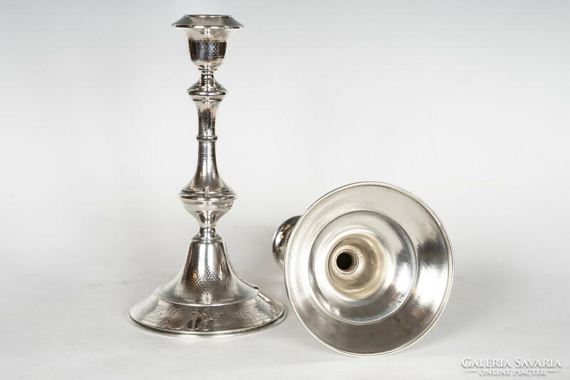 Pair of silver candle holders with delicately chiseled decor