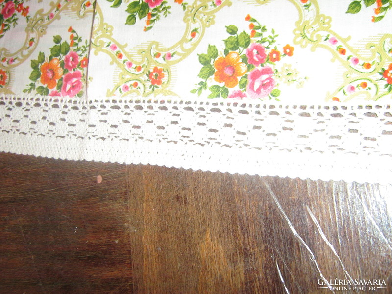 A charming baroque rose pattern tablecloth with a lace edge