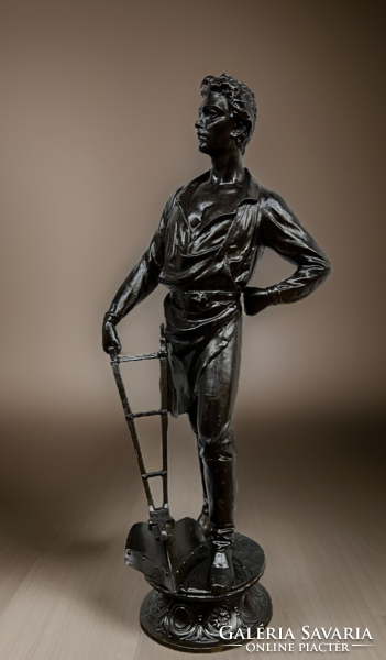 Statue of a farmer leaning on a plow