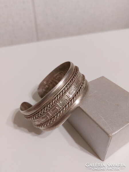 Thick ornate silver bracelet