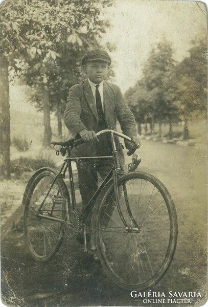 1920s. Young man with bicycle. Original paper image. Old photo. Black and white photo sheet, postcard.