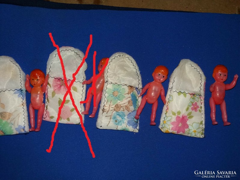 Almost antique thrift store vinyl tiny dolls in vateline swaddling pieces, according to the pictures