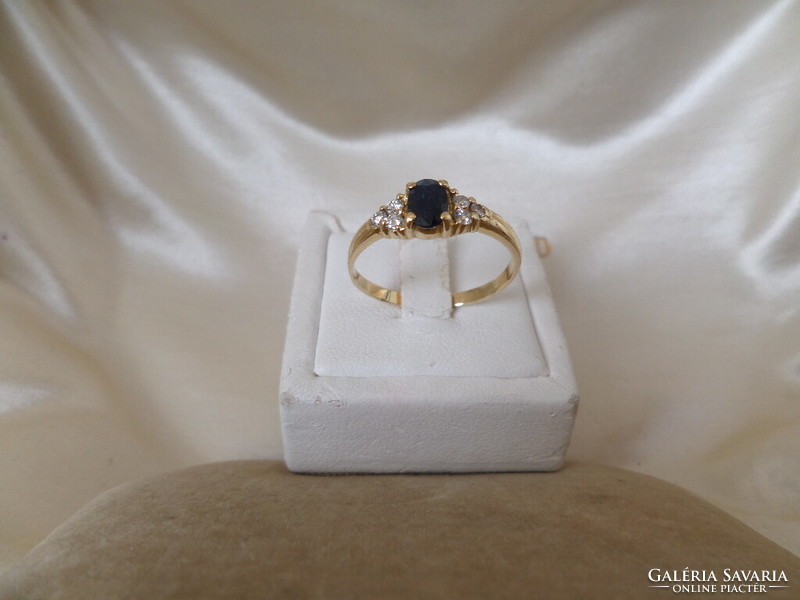 Gold ring with blue sapphire and glasses