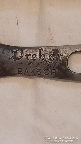 Old iron beer opener with the inscription Dreher buckser