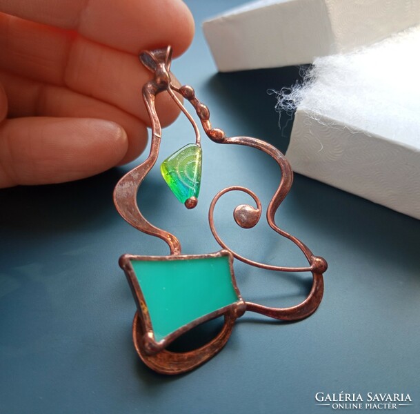 A sophisticated handcrafted product, glass jewelry pendant with turquoise glass and pearls