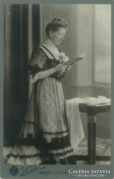 1877. Studio photo of an elegant young lady. It was taken in the studio of photographer Adéle Udari, Vienna.