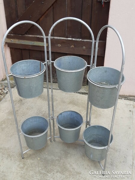 Tin containers (flower stands) on a metal frame