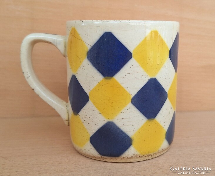 Old granite mug with rhombus pattern