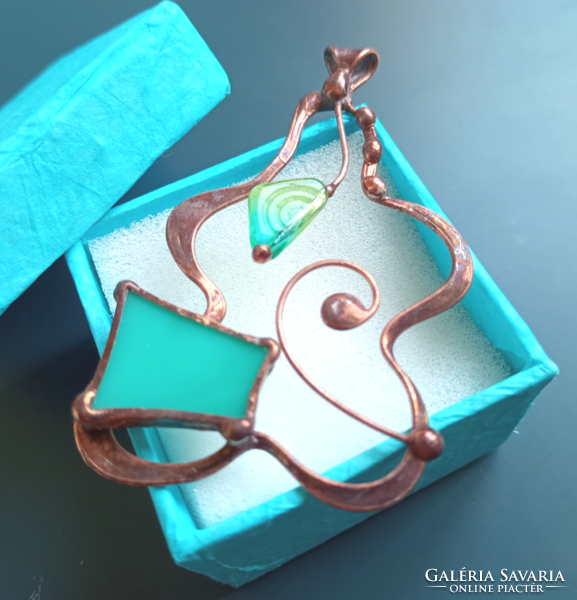 A sophisticated handcrafted product, glass jewelry pendant with turquoise glass and pearls