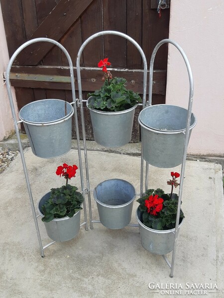 Tin containers (flower stands) on a metal frame