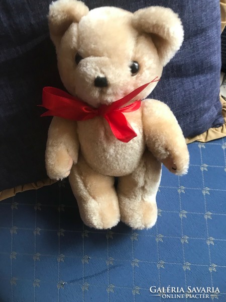 Brand new teddy bear with red bow. Size: 30 cm high and 9 cm wide.