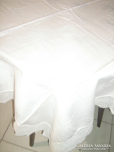 Wonderful rosy handmade crocheted snow-white damask tablecloth