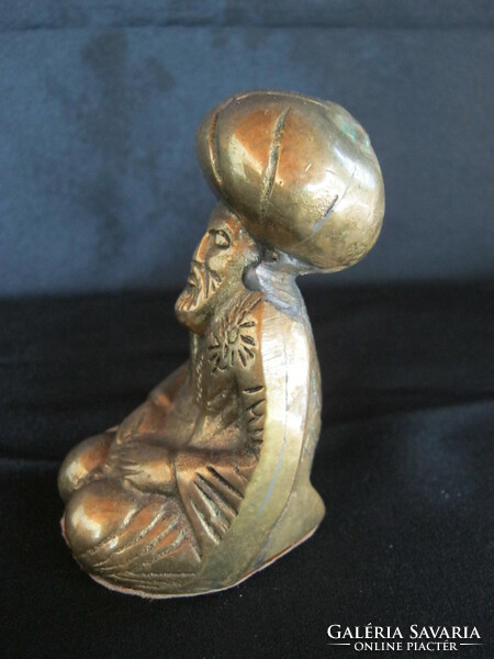 Copper figure of a praying man