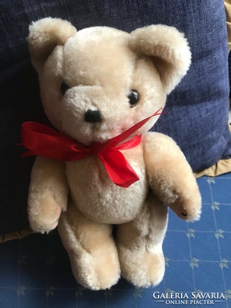 Brand new teddy bear with red bow. Size: 30 cm high and 9 cm wide.