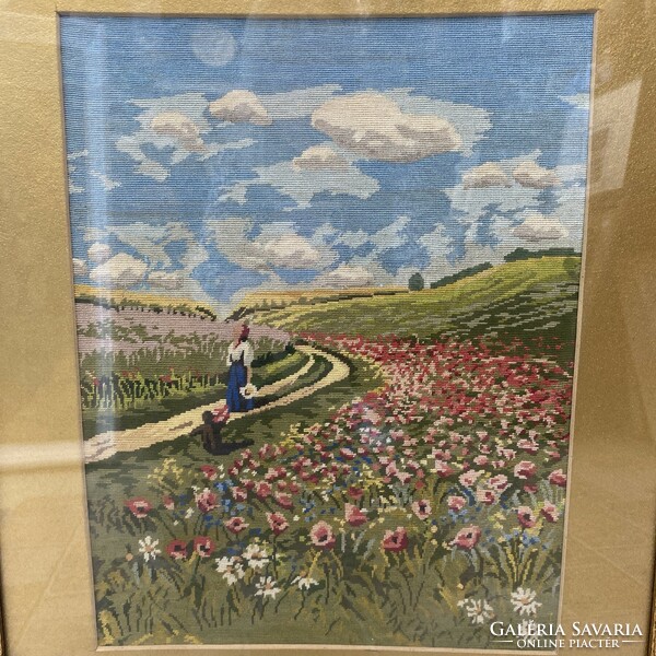 Floral meadow needle tapestry in an antique frame