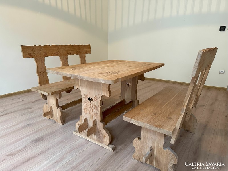 Solid wood dining table with benches, carved flower motifs