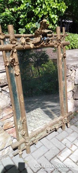 Decorated mirror with an antique wooden frame