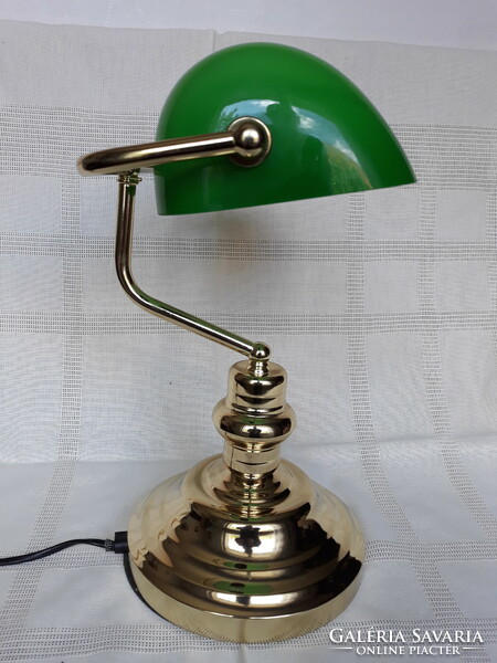 A beautiful copper bank lamp with a green glass shade