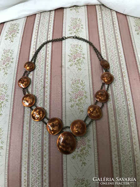 A golden brown fire enamel necklace on a copper chain made by an artisan
