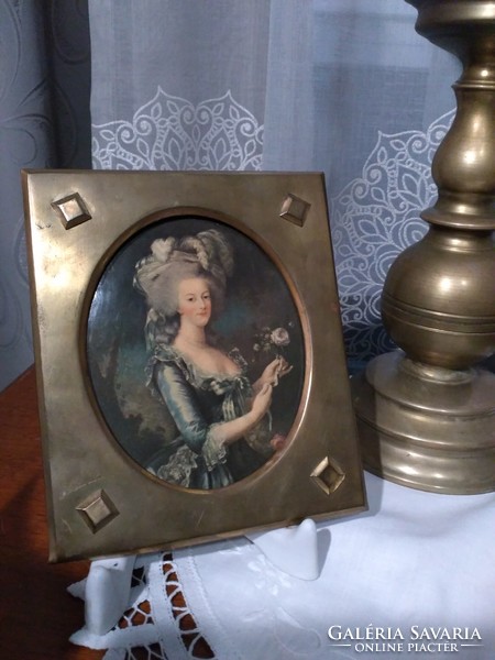 Colored embossed pictures in an antique brass frame with a portrait of Queen Marie Antoinette of France